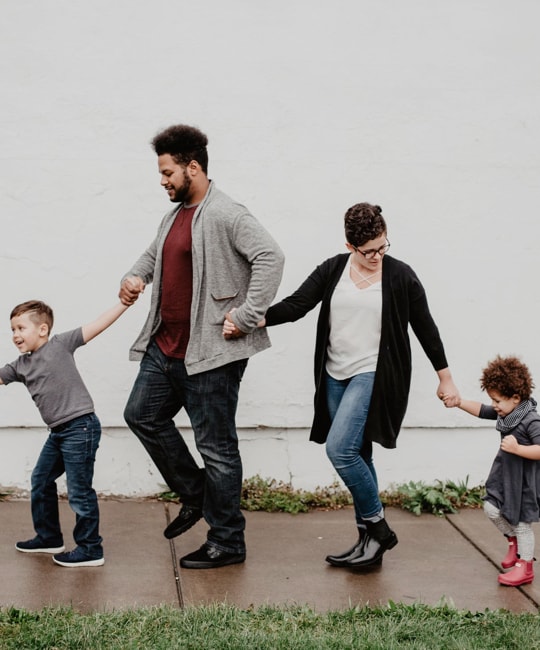 family walking on the sidewalk